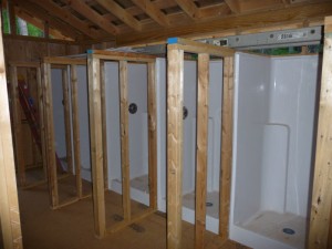 Fiberglass shower stalls in new Heigh Ho bath house.