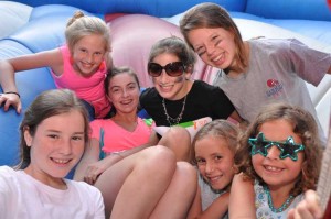 Campers enjoy the Moonwalk during the County Fair at Camp Illahee girls camp