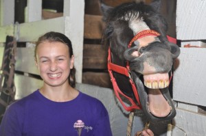 A camper and horse smile at Camp Illahee girls camp