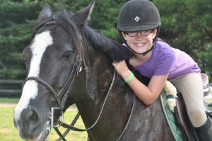 Illahee girls camp camper mounted on a horse.