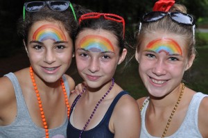 Three girls with rainbows painted on foreheads at Illahee County Fair.