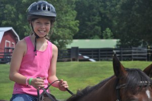 girl rides horse in camp in north carolina