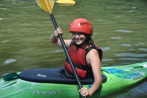 girl at camp in kayak