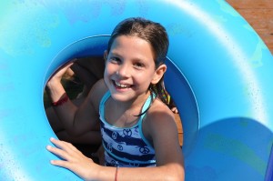 girl with swimming tube at camp