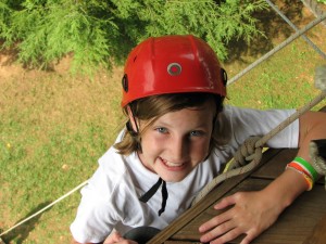 girl climbing to top of climbing tower at Illahee girls camp in NorthCarolina