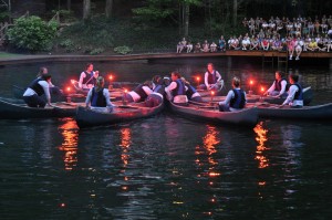 canoes maneuver in formation for final night shows