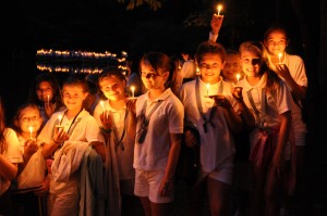 girls at camp holding candles during final night ceremonies