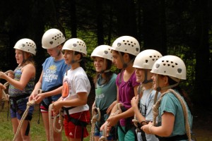Six girls campers get ready for the high ropes course.