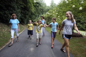 Sandy Jackson and Kris Campbell tour alumna Kathy McGrady's sister-in-law and nieces around Camp Illahee.