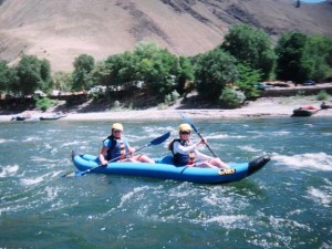 Grace and Caroline Lowe use their Illahee kayaking skills in a duckie on the Salmon river.