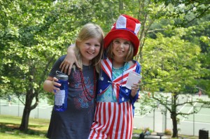 Two girls pose with july fourth attire.