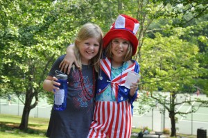 Two girls pose with july fourth attire.
