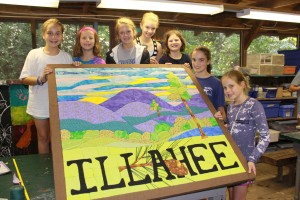 Girls at summer camp pose with Camp Illahee quilt.