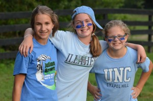 Three summer camp girls on the blue team during Capture the Flag.