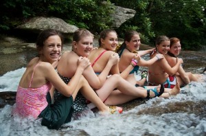 A cabin of summer camp girls gets ready to slide down Sliding Rock.