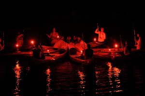 Candlelit canoes in a star formation on the swim lake.