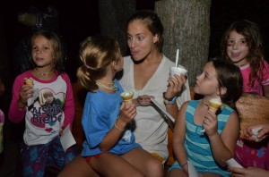 A counselor makes an ice cream face with her camper!