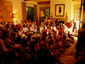 A roomful of girls and moms watching the Camp Illahee Summer Camp for Girls video in Atlanta.