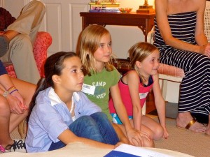 Three campers ready for the movie to start.