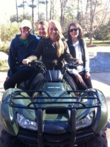 Four counselors sitting on a 4 wheeler.