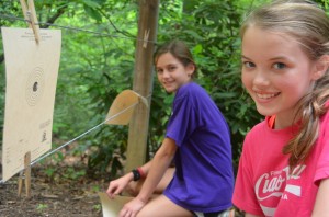 Two Camp Illahee girls check their targets in riflery activity.