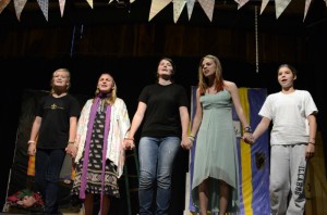 Cast members of the Best Little Theater in Town at Camp Illahee perform on stage.