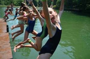 Summer Campers Jump into the Swim Lake Arms in the Air