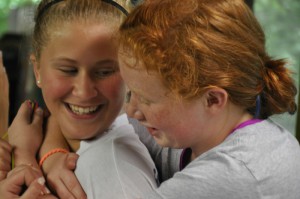 Two girls hug at Camp Illahee