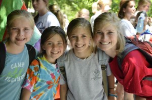 A counselor at Camp Illahee poses with three of her campers on the first day of camp.