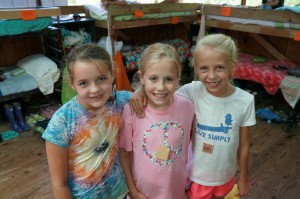 Three campers enjoy each other in the cabin.