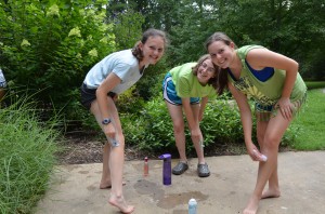 3 girls get ready for a summer camp dance by shaving their legs.