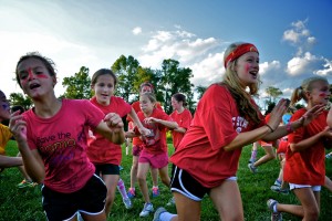 Summer camp counselors and campers leave the safety circle dressed in red.