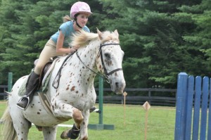 Illahee camper practices jumping during horsemanship