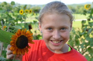 Illahee camper enjoys sunflowers at the farm