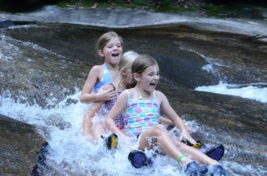 Illahee campers squeal as they zip down Pisgah Forest's Sliding Rock