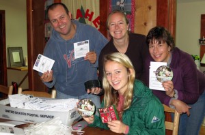 The Camp Illahee year round staff get DVDs ready to go out fro Christmas.
