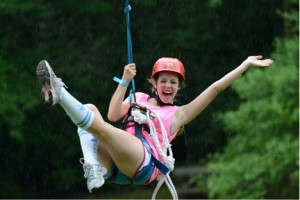 A Camp Illahee Spark sporting Illahee tall socks enjoys her first zip from the Beanstalk this season!