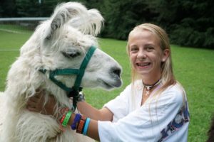 A big camper smile with a llama.