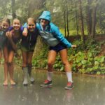 Campers enjoy a rain shower