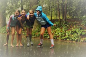 Campers enjoy a rain shower