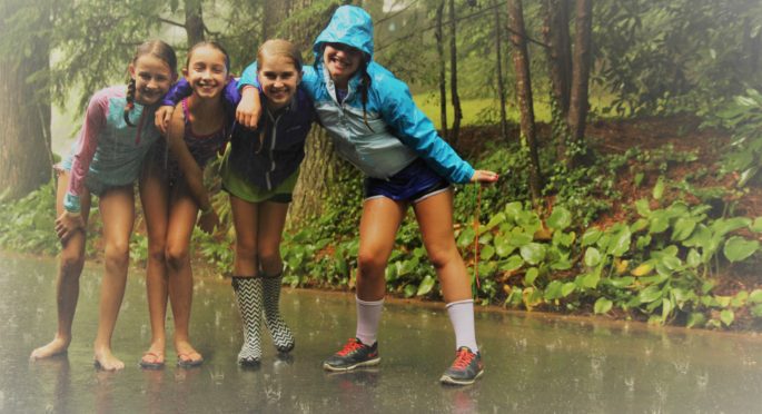 Campers enjoy a rain shower