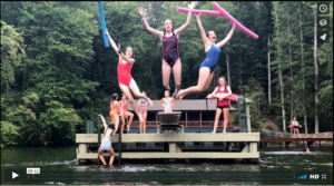 Synchronized Swimmers Begin their routine with a trio jumping off the diving board.