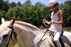 A rider takes a turn to the camera with a little smile.